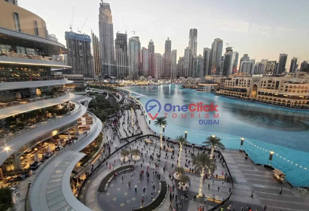 An overhead view of the Dubai Fountain area and the outdoor dining terraces at the base of the Burj Khalifa.