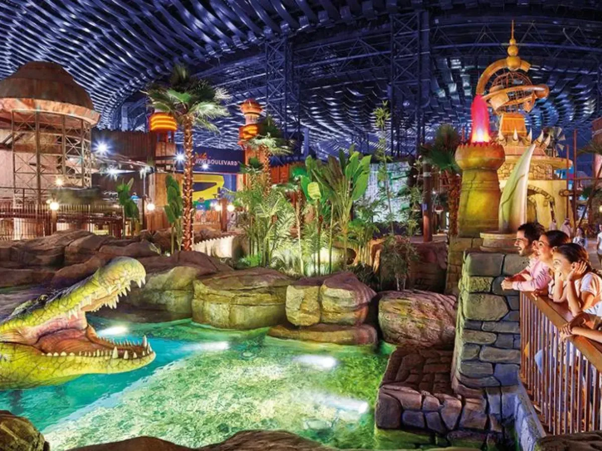 Visitors viewing a prehistoric crocodile animatronic at IMG Worlds of Adventure, the largest indoor theme park in Dubai.