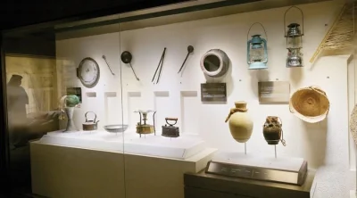 Traditional Emirati artifacts, pottery, and historic kitchenware on display at Al Ain Palace Museum